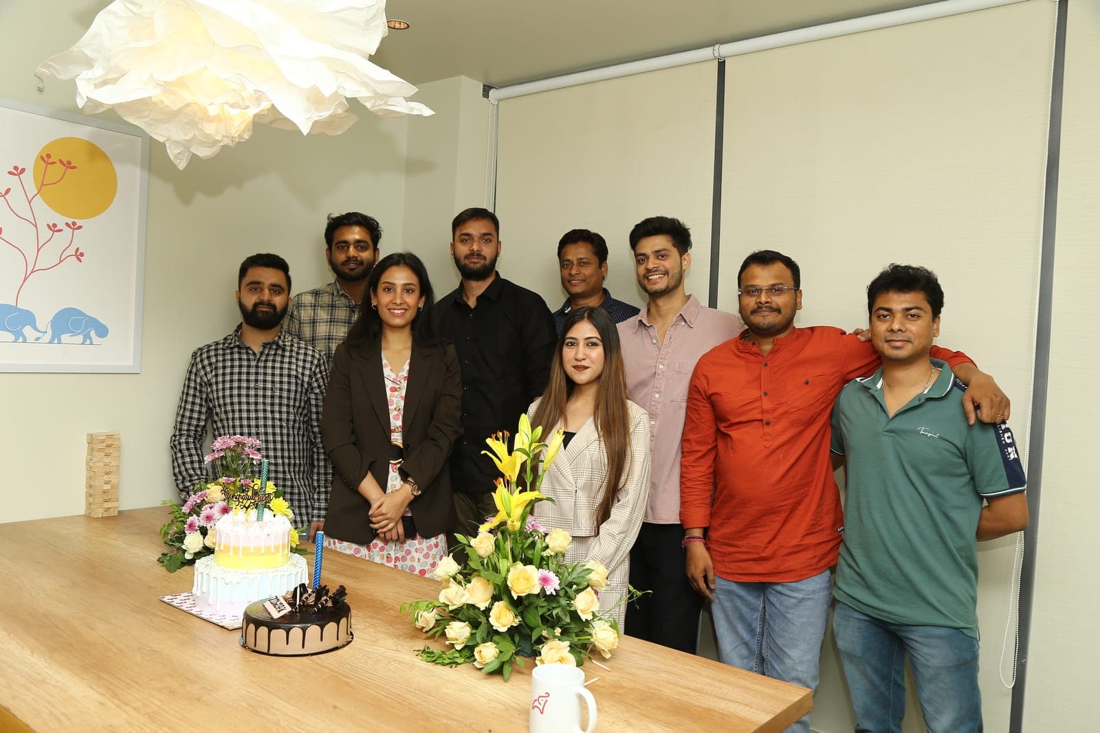 A team group photo with cake